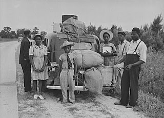 People standing around packed car