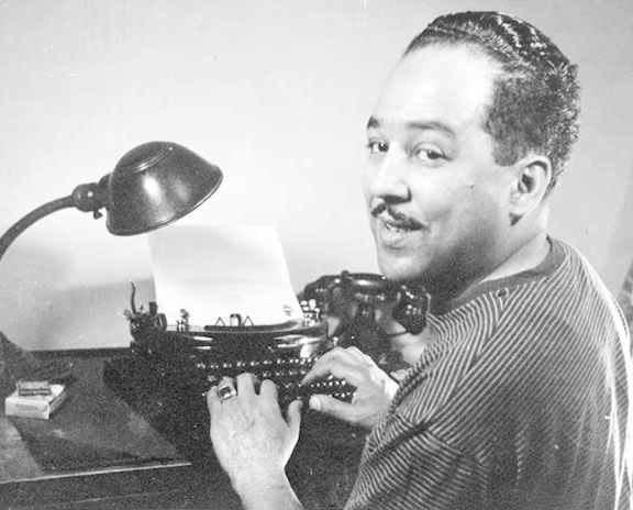 a black and white picture of person using type writer