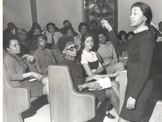 "Black and white image of Miriam teaching."