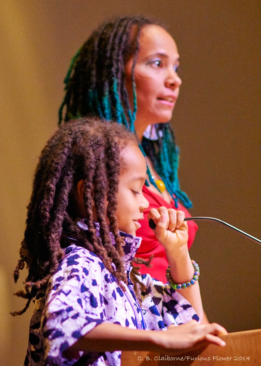 "A little girl speaking on the podium"