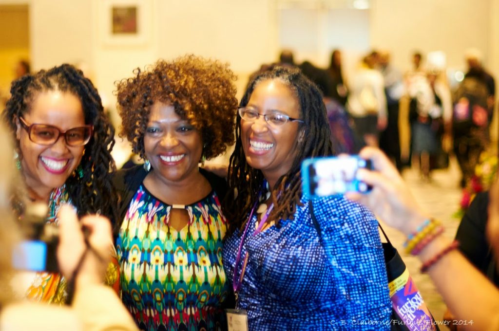 "Three women taking a group photo together"