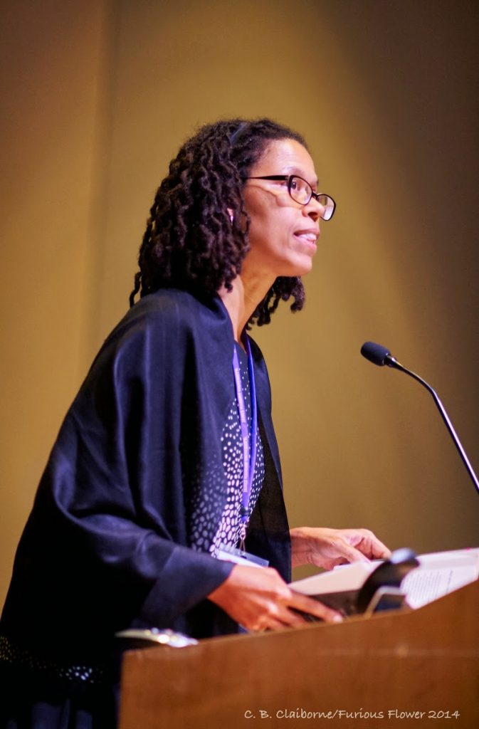 "A woman speaking at the podium"