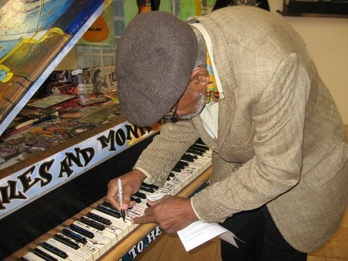 "Amiri Baraka autographing a piano key"