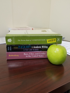 Stack of books behind an apple
