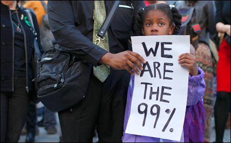 "A little girl holding a sign saying 'We are the 99%'"