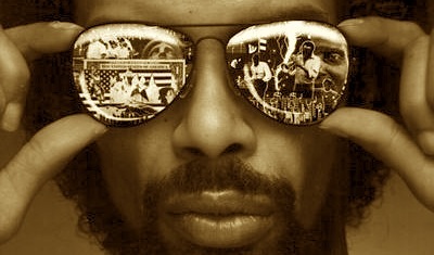 "Gold colored photo of Gil Scott-Herron wearing sunglasses"