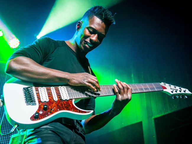 Tosin Abasi playing his electric guitar live