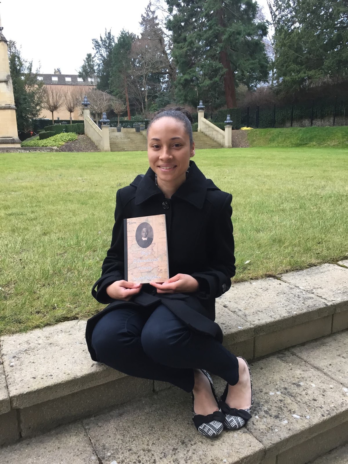 Crystal Bradshaw holding "Eliza: A Generational Journey" at the University of Oxford