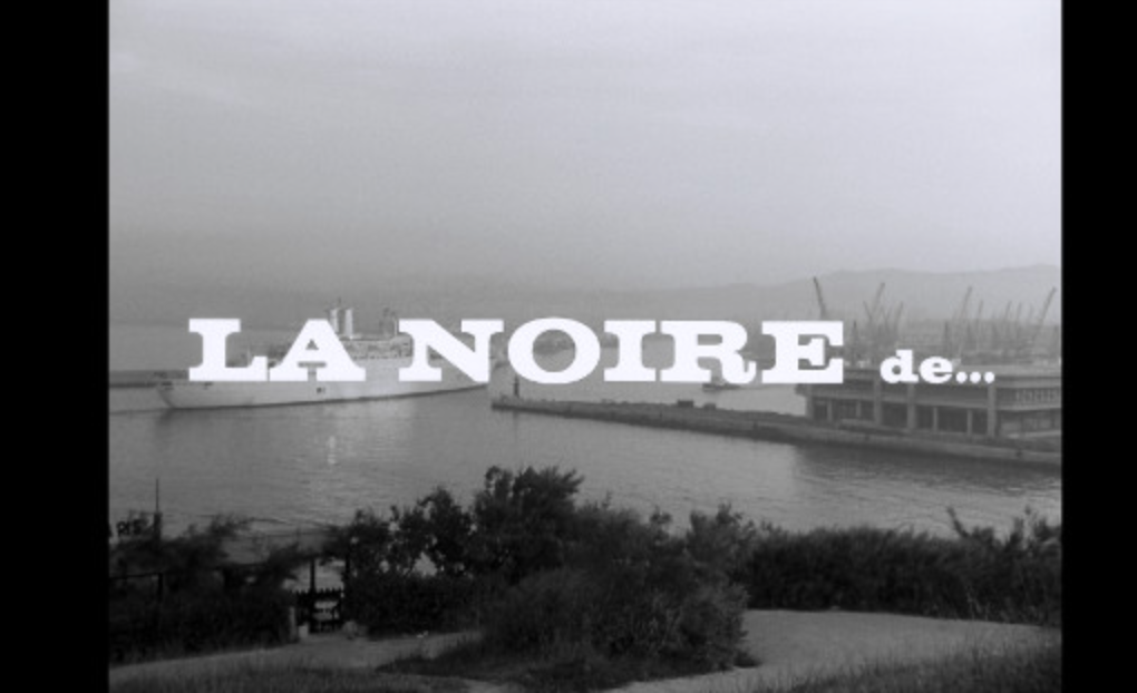 White text that prints La Noire de... with a overview of a dock in the background