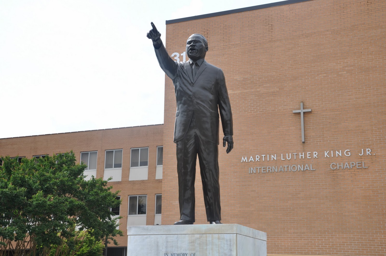 "Statue of Martin Luther King Jr. in front of the Martin Luther King Jr. International Chapel building"