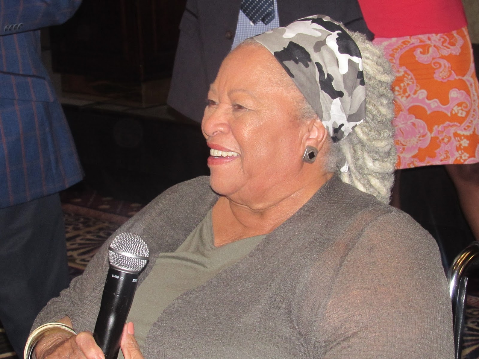 Toni Morrison sitting down with a microphone