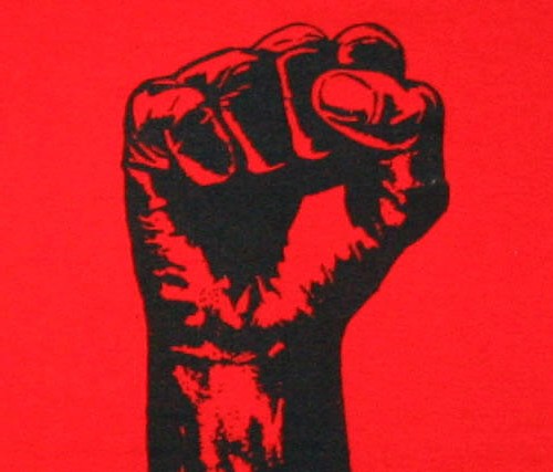 "A black fist in a red background"