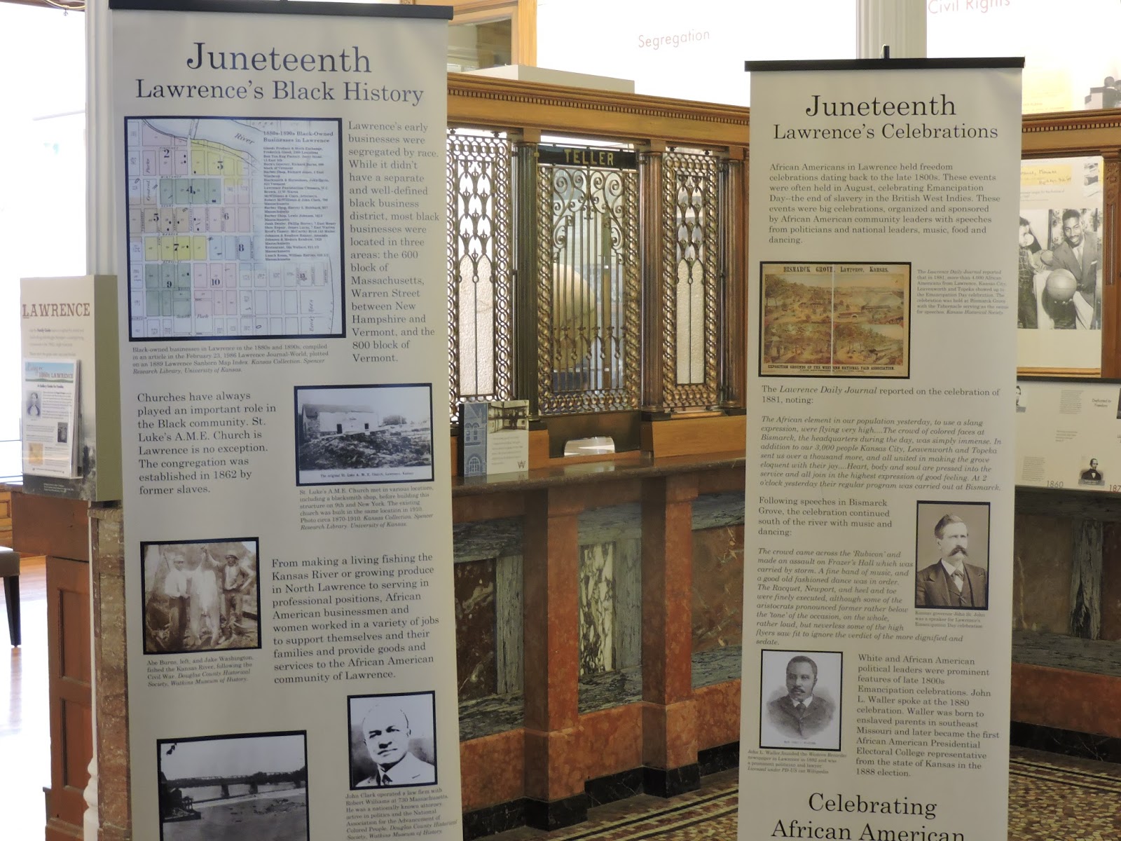 close up of two flag stands with information about Lawrence's Black History and Lawrence's Celebrations