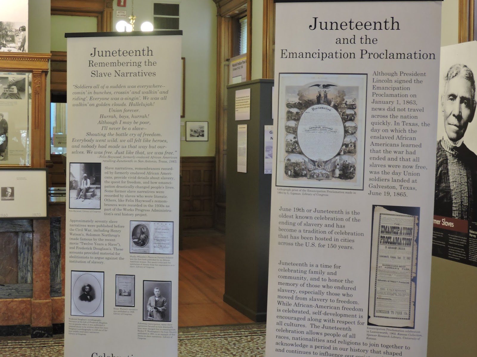 close up of two flag stands with information about Remembering the Slave Narratives and Emancipation Proclamation