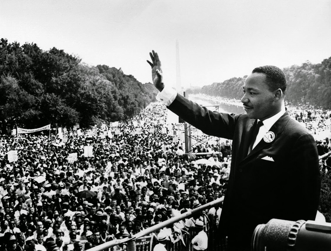 "Martin Luther King Jr.  waving to a gathered mass crowd in Washington D.C. during the Washington March in 1963"