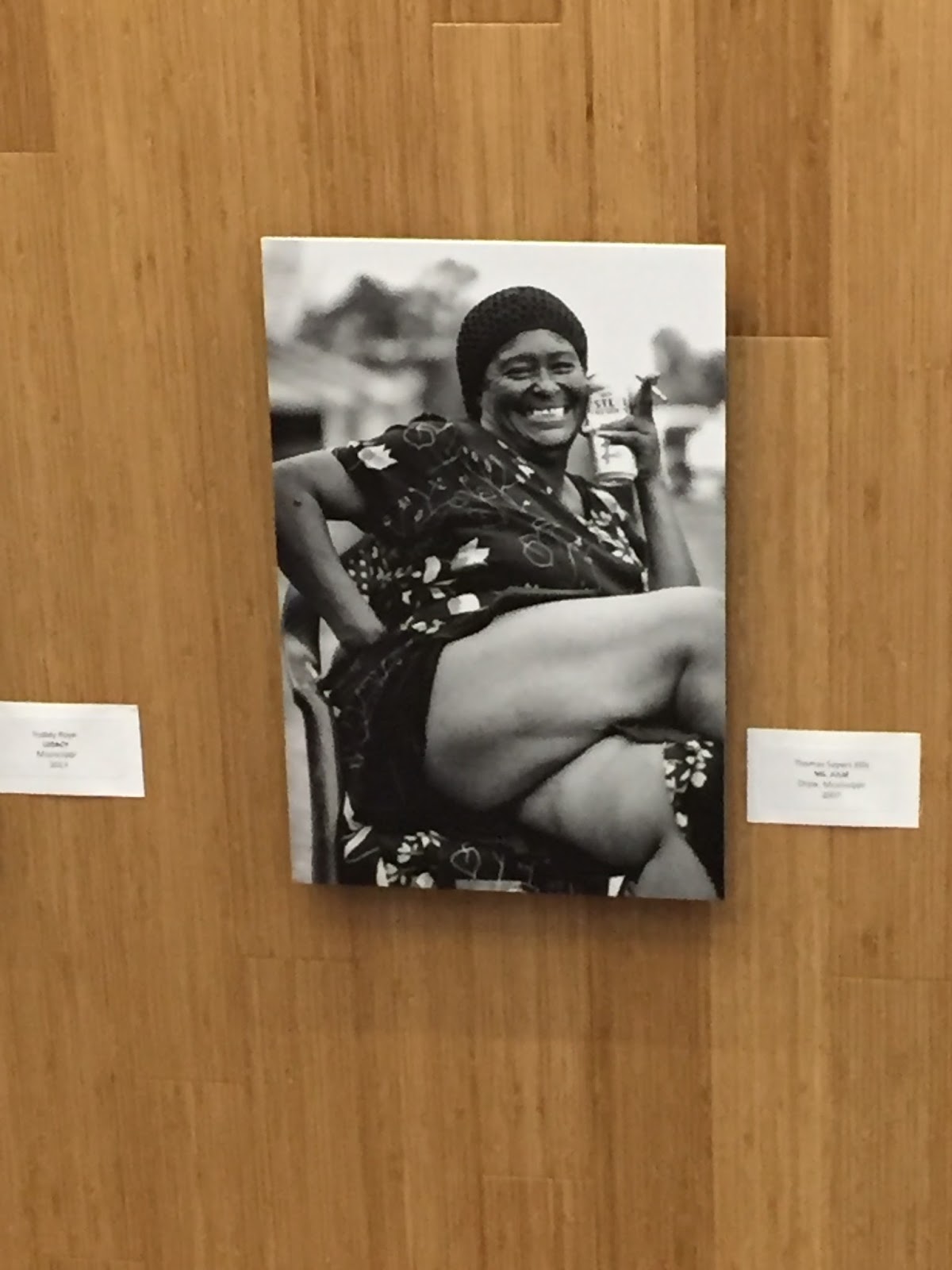 lady crossing her legs and laughing while smoking a cigarette