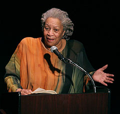 "Toni Morrison speaking on a podium"