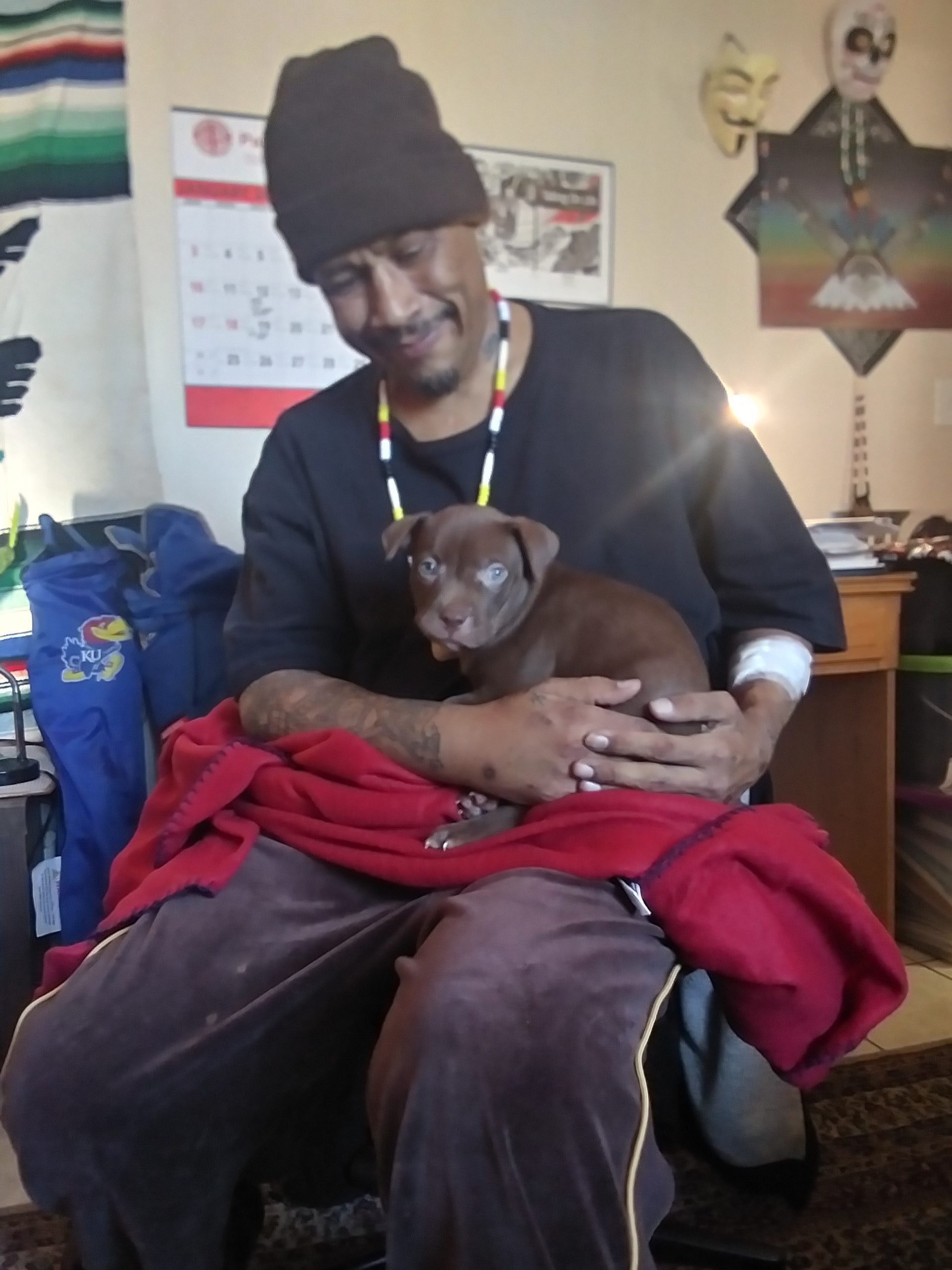 "Antonio Sanchez-Day holding a dog"