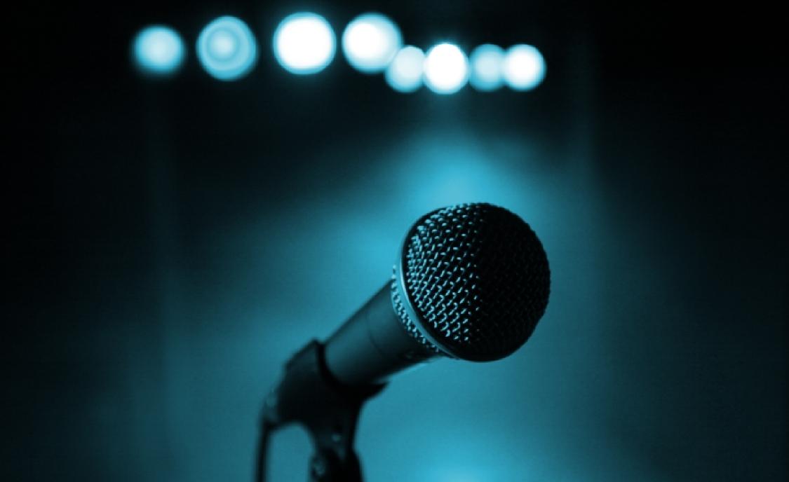 "Stock image of a mic in a blue background"