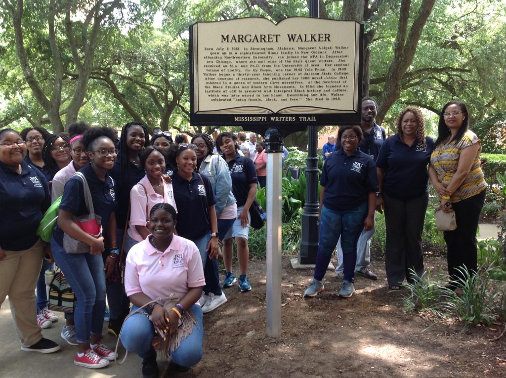 "A group of people standing next to the marker of Margaret Walker"