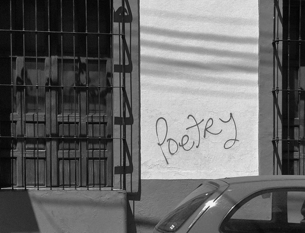 "Poetry" graffitied on a wall 